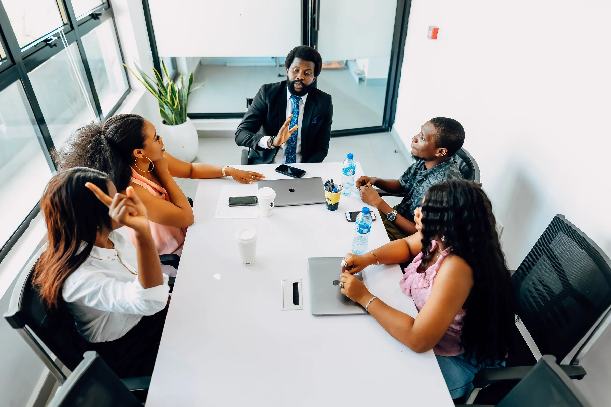 Property professionals discussing plans around a meeting table in a bright African office