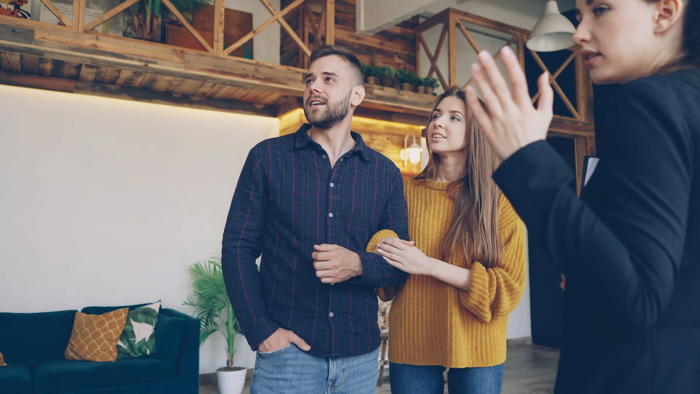 A couple viewing a warm contemporary home with a property adviser