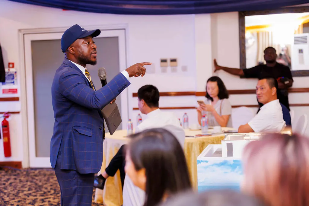 A project representative speaking with guests at the Labadi Beach Apartments presentation