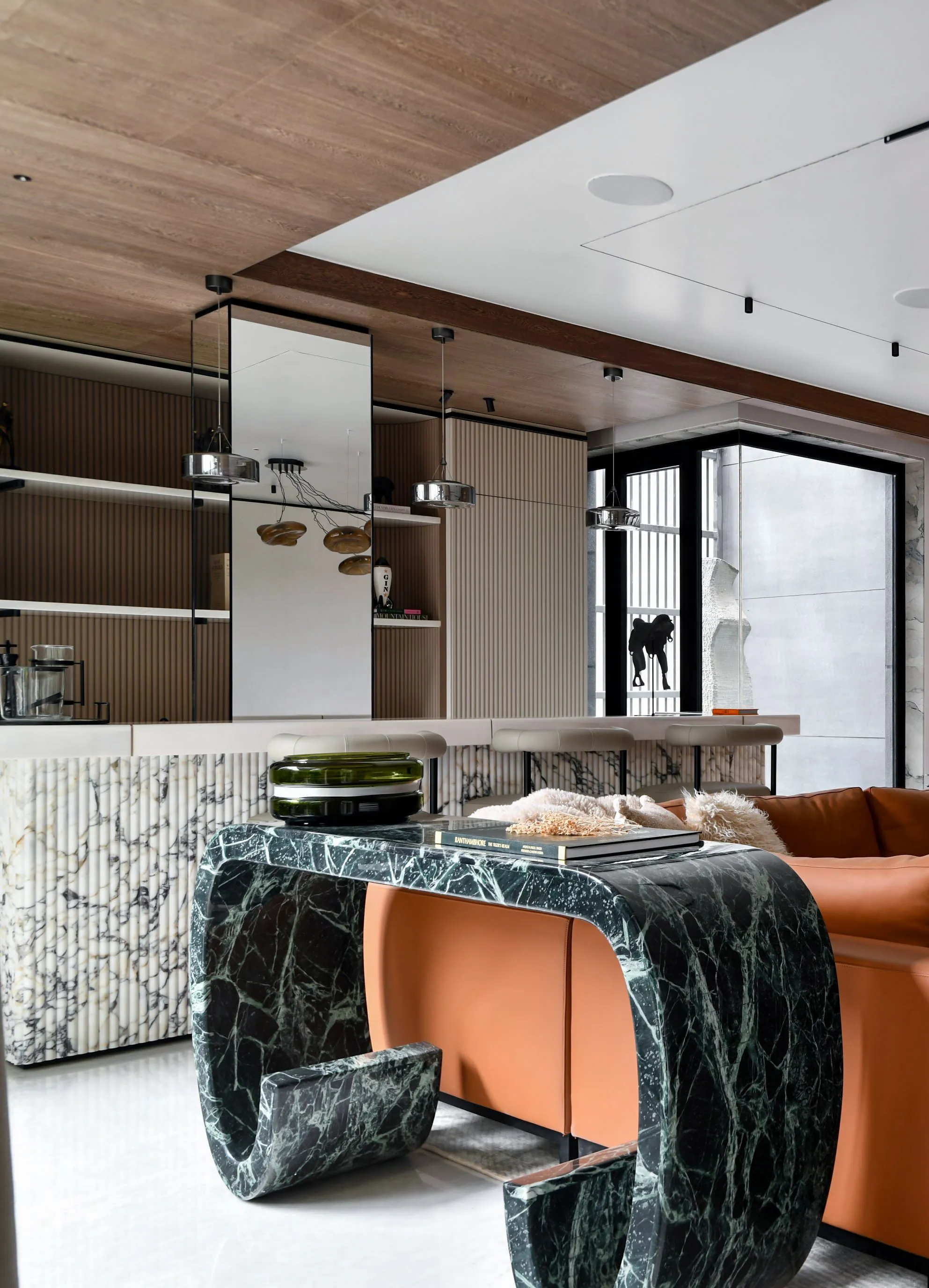 Warm contemporary living space finished with timber, marble and soft seating